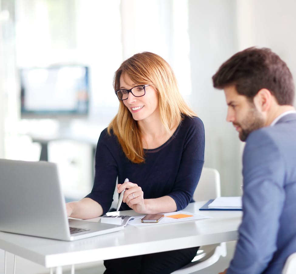 brand-monitoring-woman-discussing-work-with-colleague