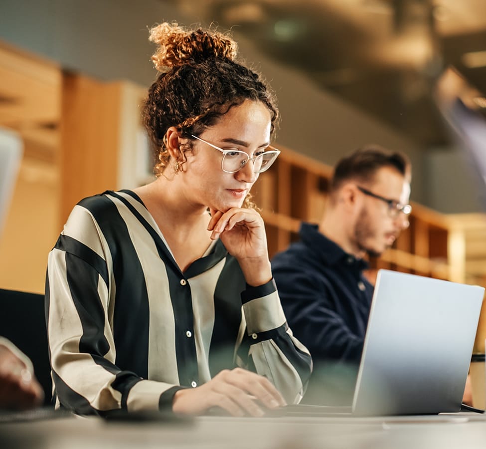 A woman looking in her laptop and working