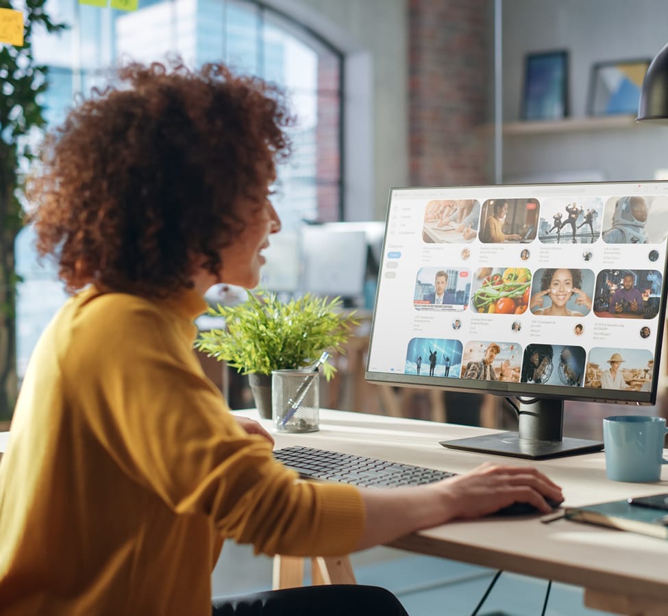 A woman looking at the images on a desktop