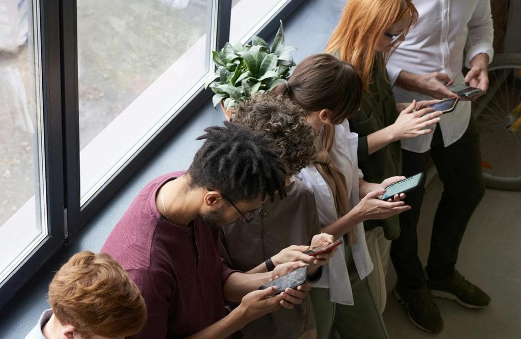 social-media-monitoring-team-looking-down-at-their-phones