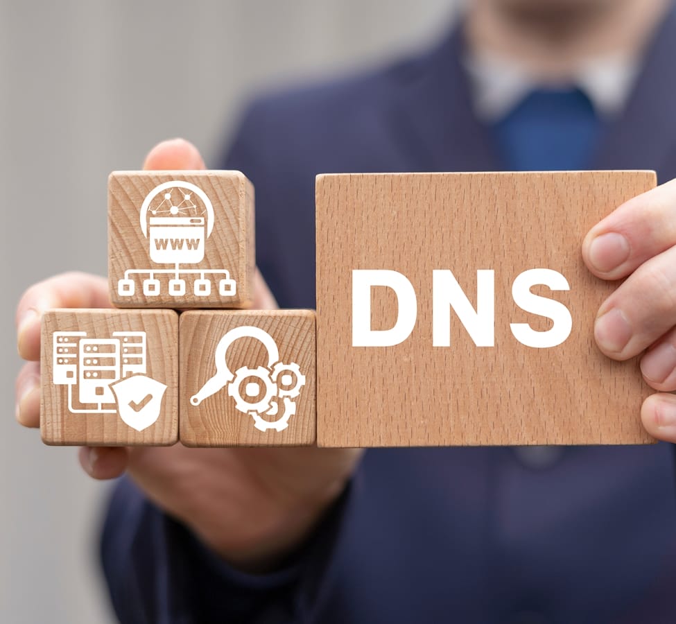 A person holding wooden blocks of DNS services